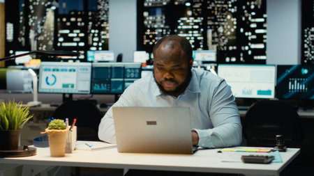 African american businessman standing in the office and searching for solutions, being pensive and...