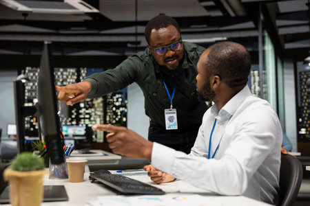 Black company advisors doing teamwork at night to meet deadlines, completing monthly reports and...