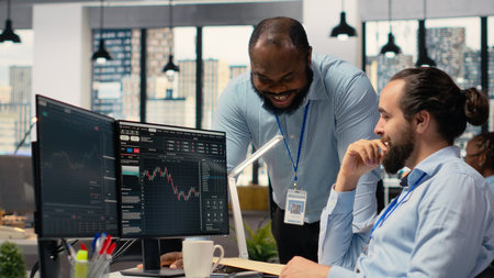 Happy coworkers in office doing high five after successful trading strategy on stock market. Joyous...