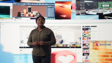 Person watches multimedia collage of modern social media networks videos. African american woman looks at visualization of data driven world with content in constant motion, camera Aの写真素材