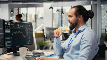 Trader in office doing brainstorming before committing to investment, smiling, expressing trust in choice. Brokerage company expert thinking before trading, showing self assuranceの写真素材