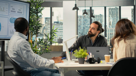 Professional workers focusing on performance metrics and data visualization, forecasting for new...