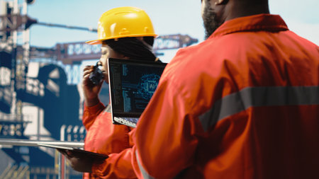 Offshore platform crew using artificial intelligence program on laptop to optimize drilling...