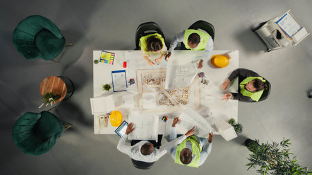 Top down view of developers in modern office environment planning construction. Architects and...