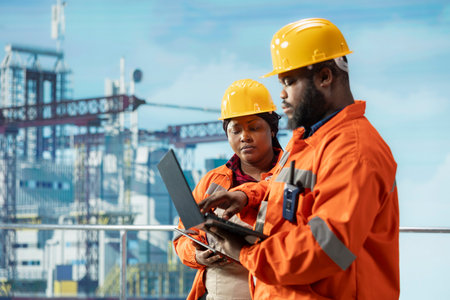 Team of environmental officers inspect offshore platform equipment for pollution control compliance. Drilling rig teamworking colleagues evaluate waste management systems to reduce ocean contaminationの写真素材