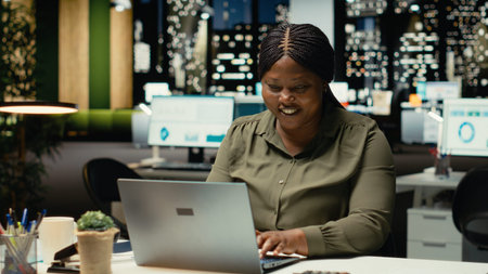 Overjoyed delighted person reading good news in her emails at night, celebrating a career...