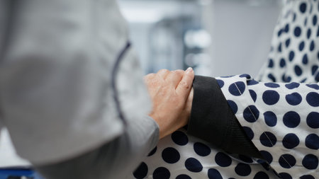 Close up of nurse reassuring her older male patient in a testing lab for clinical trial, monitoring...