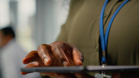 Close up of tablet used by programmer in office to accelerate complex artificial intelligence...