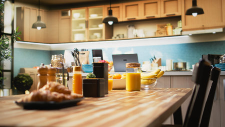 Rustic kitchen with modern furniture and elegant stylish decorations. Home interior features a countertop with organic produce, utensils and cooking essentials. Luxury comfortable living.の写真素材