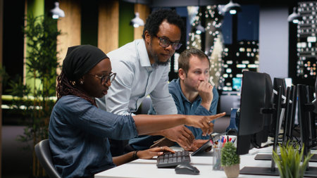 Engineering team brainstorming in office, typing code on computer, developing machine learning...