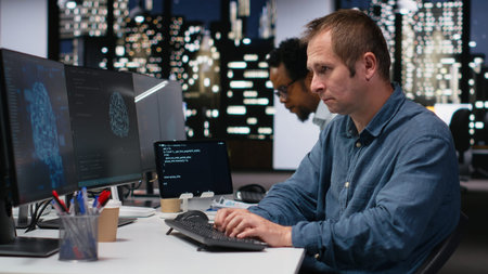 Software developer in office analyzing machine learning algorithms to prevent AI errors. Startup IT...