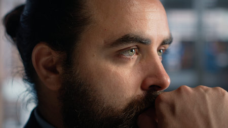 Close up of focused male thinking about options and business ideas, planning a management strategy. Businessman professional with reflective face, showcasing concentration and authority.の写真素材