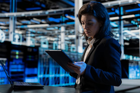 Data center programmer using tablet to install and configure equipment hosting digital services....