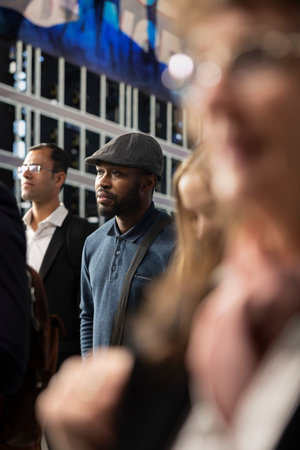 African american casual pedestrian walking along crowded streets surrounded by multiethnic group of...