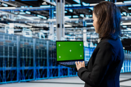 Green screen laptop used by server farm admin to do maintenance on equipment, AR visualization...