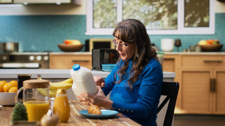Old man and woman reading ingredients on organic product label, being conscious about eco friendly sustainable food for healthy lifestyle and balanced meal choice. Wellness and longevity. Camera B.の写真素材
