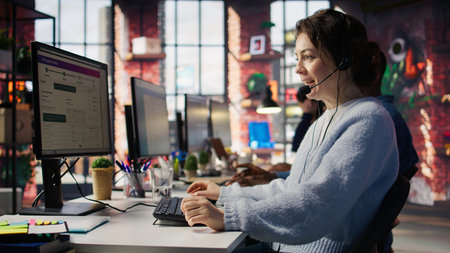 Happy call center agent in office helping customers by answering questions, solving issues. Smiling...