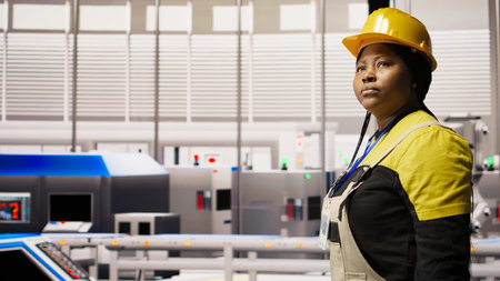 Engineer in smart factory overseeing robotic assembly lines, ensuring quality control in...