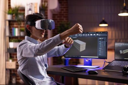 Freelancer with VR headset, developing and modifying 3D product models using cad software at home. Asian man interacts with virtual design projects, combining creativity and futuristic technologyの写真素材
