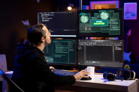 Cybercriminal using malicious spyware program to compromise devices and digital networks, gaining...
