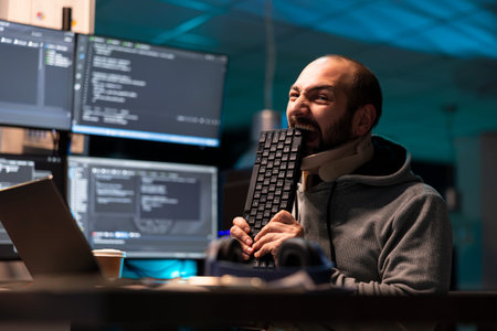 Irritated programmer presses face against keyboard in frustration, overwhelmed by repeated technical...