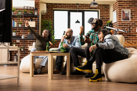 Cheerful group of friends enjoys weekend VR gaming in modern apartment. Diverse people engage in...