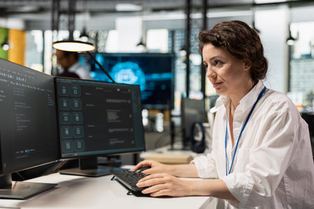 Computer scientist running AI large language model chatbot on PC in startup workspace. IT...
