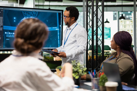 IT specialist in startup office doing presentation on machine learning to management. Computer...