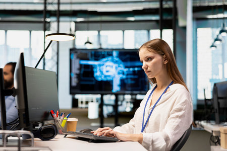 Junior dev in tech startup utilizing AI to optimize performance and forecast issues. Young female...
