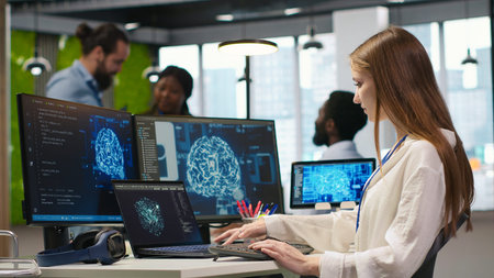 Junior developer in office integrating AI machine learning systems to streamline workflows. Young...