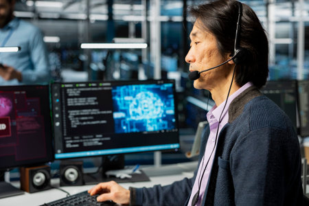 Technician in server farm doing tech support, fixing hacking warnings, securing systems from...