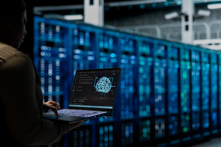 Data center engineer using AI technology on laptop to troubleshoot backend operations gear. Server...