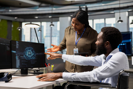 Manager overseeing tasks progress done by worker with paraplegia using AI to fix glitches. Team...