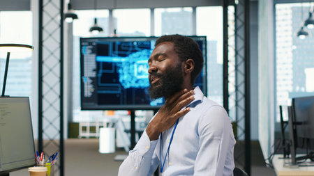 System administrator in tech startup office using PC, troubleshooting hardware and software issues....