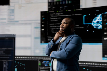 African american software engineer immersed in code development, studying programming language for...