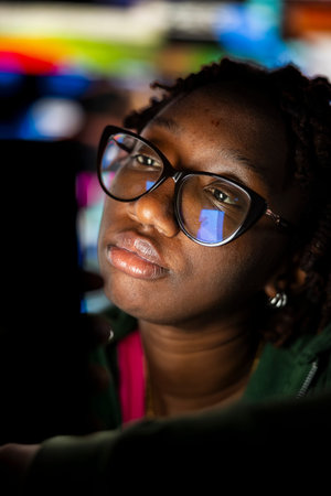 Woman looking at phone screen with dull expression, showing boredom and lack of motivation while...