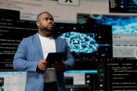 Black software expert focusing on programming language for innovation, reading binary code on terminal window. Reviews code development for data science. Modern futuristic coding life.の写真素材