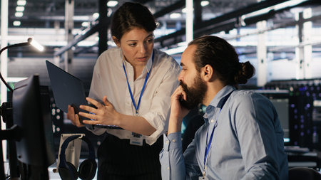 Data center admins working together, collaborating on neural network software development....