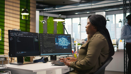 Female technician writing code on PC, developing neural networks APIs. System administrator using...