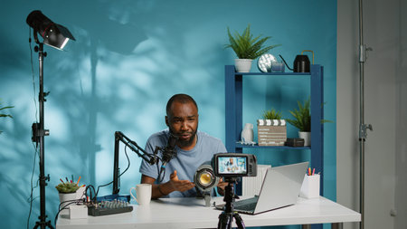 Black influencer talking about studio light for vlog review on camera. African american vlogger...