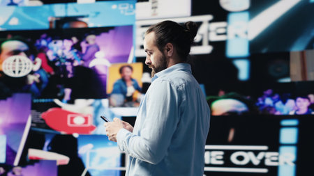 Casual man texting on his phone and enjoying social media connection, social platforms visuals and...