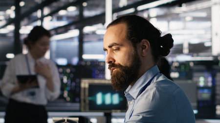 Engineer in data center reorganizing desk items at workstation to streamline workflow and boost...