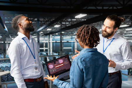 Diverse staff members worrying about malicious hacking cyber attack, dangerous data breach with...