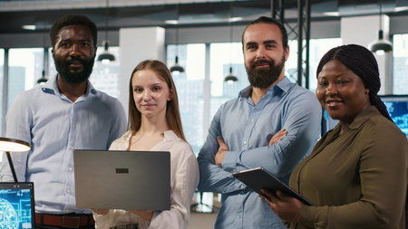 Portrait of happy teamworking engineers writing code, developing machine learning APIs. Team of...