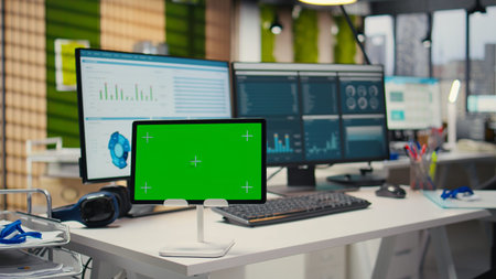 Empty office showcases tablet with isolated chroma key and modern tools for essential business...
