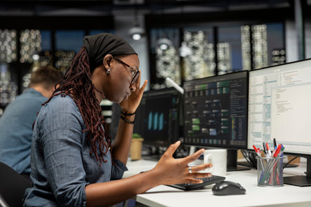 Engineer feeling disappointed in startup office after noticing error in machine learning code while...