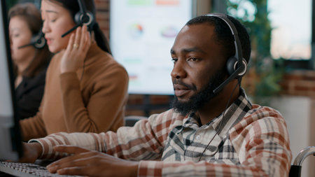 Young man answering telework call at customer service job, talking to clients on phone helpline....