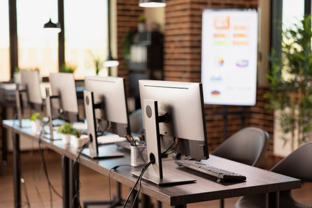 Vacant and organized brick wall office featuring a table and digital equipment for startup company....