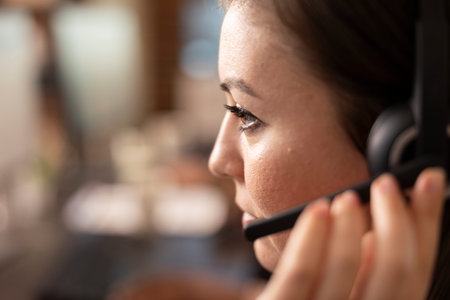 Caucasian customer service specialist with hands free headset, focused on providing technical...