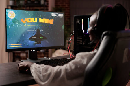 Gamer celebrating winning online multiplayer science fiction videogame tournament. African american...